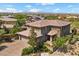 Aerial view showcasing the beautiful home exterior, landscaping, and spacious driveway at 10470 Dove Meadow Way, Las Vegas, NV 89135