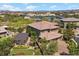 Beautiful multi-story home featuring mature landscaping, a covered outdoor living area, and a paver driveway at 10470 Dove Meadow Way, Las Vegas, NV 89135
