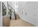 Bright foyer with a modern staircase, wood floors, and ample natural light at 10470 Dove Meadow Way, Las Vegas, NV 89135