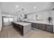 Large kitchen island with stone countertop and stainless steel appliances offer great space to cook at 10470 Dove Meadow Way, Las Vegas, NV 89135