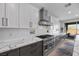 Gourmet kitchen features stone countertops, tile backsplash, and a stainless steel range and oven at 10470 Dove Meadow Way, Las Vegas, NV 89135