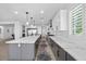 Modern kitchen island with sleek countertops and stainless steel appliances adjacent to the dining room at 10470 Dove Meadow Way, Las Vegas, NV 89135