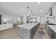 Open kitchen features an island with stone countertop, stainless steel appliances, and recessed lighting at 10470 Dove Meadow Way, Las Vegas, NV 89135