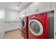 Laundry room equipped with a washer, dryer, storage cabinets and countertops at 10470 Dove Meadow Way, Las Vegas, NV 89135