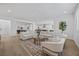 Bright and airy living room features a stylish seating arrangement and view of the kitchen at 10470 Dove Meadow Way, Las Vegas, NV 89135