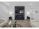 Modern living room featuring a sleek fireplace and minimalist decor with comfortable seating at 10470 Dove Meadow Way, Las Vegas, NV 89135