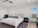 Bright main bedroom featuring a ceiling fan, shuttered windows, neutral color palette, and wood-look flooring at 10470 Dove Meadow Way, Las Vegas, NV 89135