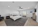 Bright main bedroom with a ceiling fan, large windows with shutters, stylish décor, and wood-look flooring at 10470 Dove Meadow Way, Las Vegas, NV 89135