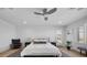 Bright main bedroom featuring a ceiling fan, shuttered windows, neutral color palette, and wood-look flooring at 10470 Dove Meadow Way, Las Vegas, NV 89135