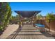 Outdoor kitchen and pergola area featuring stone columns, built-in grill, and ample counter space at 10470 Dove Meadow Way, Las Vegas, NV 89135