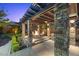 Charming outdoor space with a stone pergola, inviting fire pit, and built-in grill at 10470 Dove Meadow Way, Las Vegas, NV 89135