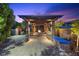 Luxurious outdoor living space with a stone pergola, fire pit, and built-in grill at 10470 Dove Meadow Way, Las Vegas, NV 89135