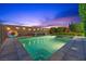Backyard pool at dusk with beautiful lighting and mature landscaping at 10470 Dove Meadow Way, Las Vegas, NV 89135