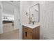 Contemporary powder room with modern wallpaper and wood vanity at 10470 Dove Meadow Way, Las Vegas, NV 89135