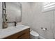 Stylish powder room features modern wallpaper and a sleek vanity at 10470 Dove Meadow Way, Las Vegas, NV 89135