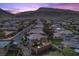 Panoramic view of a residential street with houses and mountain backdrop at dusk at 10470 Dove Meadow Way, Las Vegas, NV 89135
