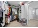 Organized walk-in closet featuring custom shelving, hanging storage and access to the bathroom at 10470 Dove Meadow Way, Las Vegas, NV 89135