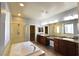 Bright primary bathroom with double sinks, vanity, granite counters, tiled flooring and large tub at 11416 Belmont Lake Dr # 102, Las Vegas, NV 89135