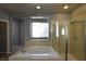 Bright bathroom featuring a relaxing soaking tub and a glass shower enclosure at 11416 Belmont Lake Dr # 102, Las Vegas, NV 89135
