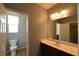 Neutral bathroom features a toilet, sink, mirror and great lighting at 11416 Belmont Lake Dr # 102, Las Vegas, NV 89135