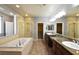 Primary bathroom with double sink vanity, shower, closet, and large bathtub at 11416 Belmont Lake Dr # 102, Las Vegas, NV 89135