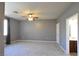 Large bedroom with neutral carpet, ceiling fan, and access to the ensuite bathroom at 11416 Belmont Lake Dr # 102, Las Vegas, NV 89135