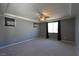 Spacious primary bedroom with grey walls, modern ceiling fan, and carpeted floor at 11416 Belmont Lake Dr # 102, Las Vegas, NV 89135