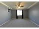 Primary bedroom featuring modern ceiling fan, carpet, neutral walls and natural light at 11416 Belmont Lake Dr # 102, Las Vegas, NV 89135