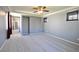 Open primary bedroom showcasing carpeted flooring, grey walls, and tray ceiling at 11416 Belmont Lake Dr # 102, Las Vegas, NV 89135