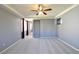 Large primary bedroom featuring carpeted flooring, grey walls, and tray ceiling at 11416 Belmont Lake Dr # 102, Las Vegas, NV 89135