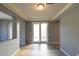 Bright entryway featuring neutral paint, and a sliding glass door leading to outdoor space, with tile and laminate flooring at 11416 Belmont Lake Dr # 102, Las Vegas, NV 89135