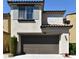 Modern home exterior with an attached garage, tile roof, and manicured landscaping at 11416 Belmont Lake Dr # 102, Las Vegas, NV 89135