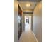 Hallway featuring grey walls, carpeted floor, wooden cabinet, and access to other rooms at 11416 Belmont Lake Dr # 102, Las Vegas, NV 89135
