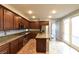 Updated kitchen featuring granite countertops, stainless steel appliances, wood cabinets, and tile flooring at 11416 Belmont Lake Dr # 102, Las Vegas, NV 89135