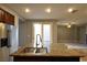 Spacious kitchen featuring granite island, stainless steel appliances, wood cabinets, and an open flow to the living area at 11416 Belmont Lake Dr # 102, Las Vegas, NV 89135