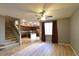 Open-concept living room with staircase access, wood floors, and a view of the modern kitchen at 11416 Belmont Lake Dr # 102, Las Vegas, NV 89135