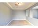 Clean living room with neutral paint, trey ceiling, vinyl floors and large windows at 11416 Belmont Lake Dr # 102, Las Vegas, NV 89135
