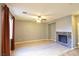 Well-lit living room with wood flooring, a ceiling fan, and a cozy marble fireplace at 11416 Belmont Lake Dr # 102, Las Vegas, NV 89135