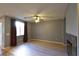 Bright living room featuring wood floors, a ceiling fan, and a charming marble fireplace at 11416 Belmont Lake Dr # 102, Las Vegas, NV 89135