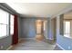 Bright living room featuring vinyl plank floors, neutral paint, and view to the hallway and entry door at 11416 Belmont Lake Dr # 102, Las Vegas, NV 89135