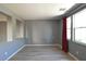 Bright living room featuring vinyl plank floors, neutral paint, and large windows with curtains at 11416 Belmont Lake Dr # 102, Las Vegas, NV 89135