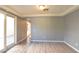 Bright living room featuring vinyl plank floors, neutral paint, and sliding doors to the backyard at 11416 Belmont Lake Dr # 102, Las Vegas, NV 89135