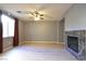 Spacious living room boasts a ceiling fan, wood flooring, and a marble fireplace at 11416 Belmont Lake Dr # 102, Las Vegas, NV 89135