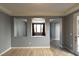 Open-concept living area with decorative wall cutouts, neutral paint, seamlessly connecting spaces with stylish flooring at 11416 Belmont Lake Dr # 102, Las Vegas, NV 89135