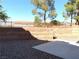 This backyard features low-maintenance landscaping and a tall retaining wall at 1152 Paradise Desert Ave, Henderson, NV 89002