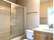 Bathroom with shower featuring glass door, a single sink, and a framed mirror above the countertop at 1152 Paradise Desert Ave, Henderson, NV 89002