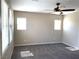Spacious bedroom with a ceiling fan, plush carpet, and ample natural light from multiple windows at 1152 Paradise Desert Ave, Henderson, NV 89002
