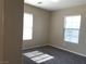 Bedroom featuring gray carpeting, neutral walls, and bright windows offering ample natural light at 1152 Paradise Desert Ave, Henderson, NV 89002