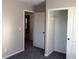 Bedroom featuring plush carpet, neutral paint, and an open closet with white sliding doors at 1152 Paradise Desert Ave, Henderson, NV 89002