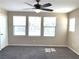 Well-lit bedroom featuring neutral walls, plush carpeting, and a ceiling fan for added comfort at 1152 Paradise Desert Ave, Henderson, NV 89002